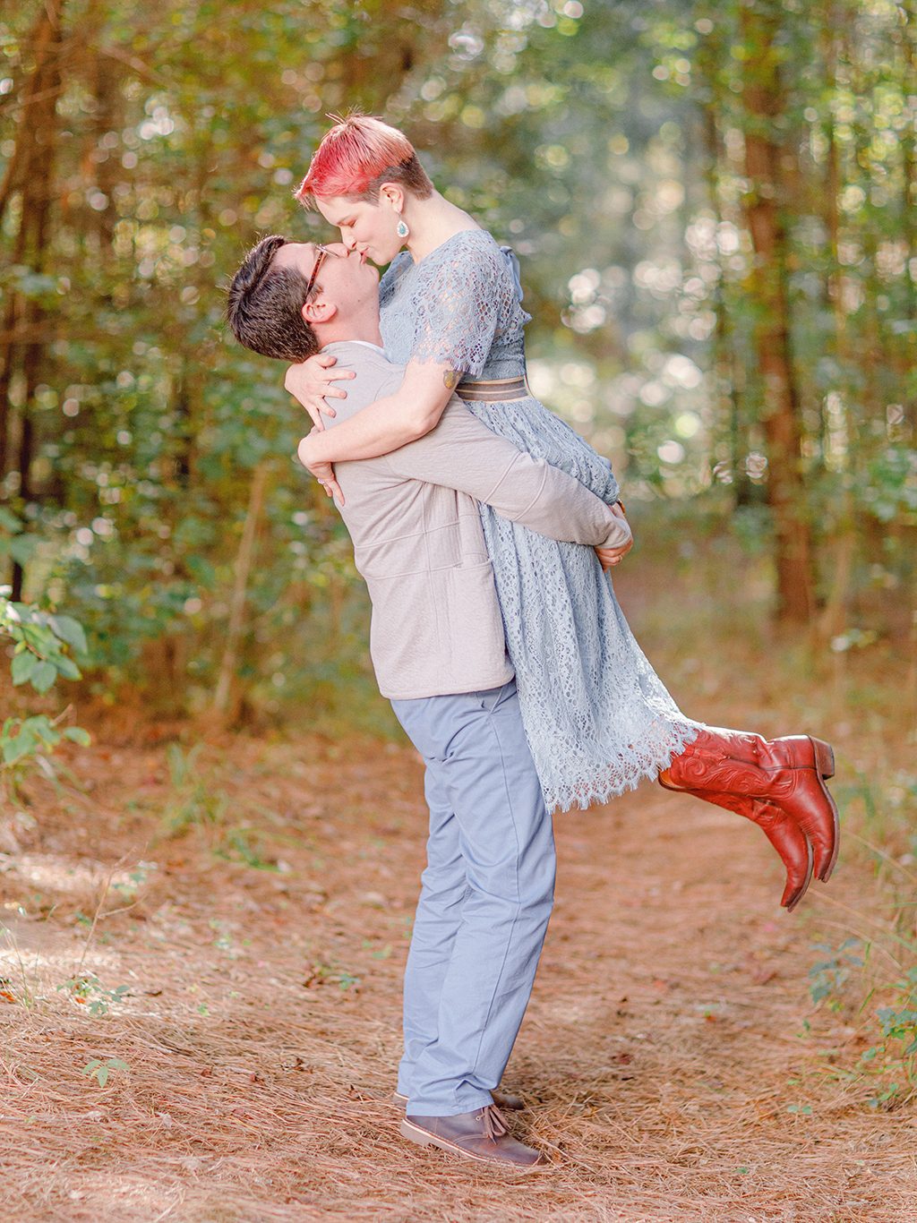 love portrait of parents kissing in woods of Oconee County, GA.