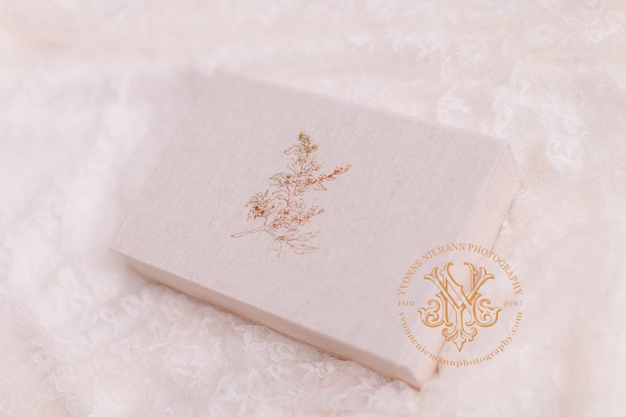 Product photography by professional Athens, GA photographer of an heirloom box covered in linen material and embossed with a gold foil dogwood tree.