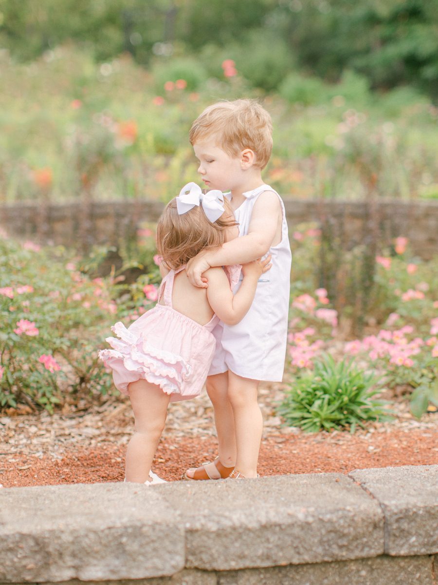 Summer child portrait photography of two siblings hugging in Athens, GA.