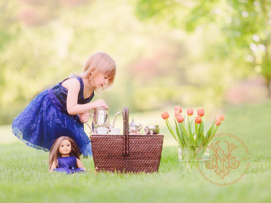 little-girl-having-a-tea-party-with-her-american-girl-doll