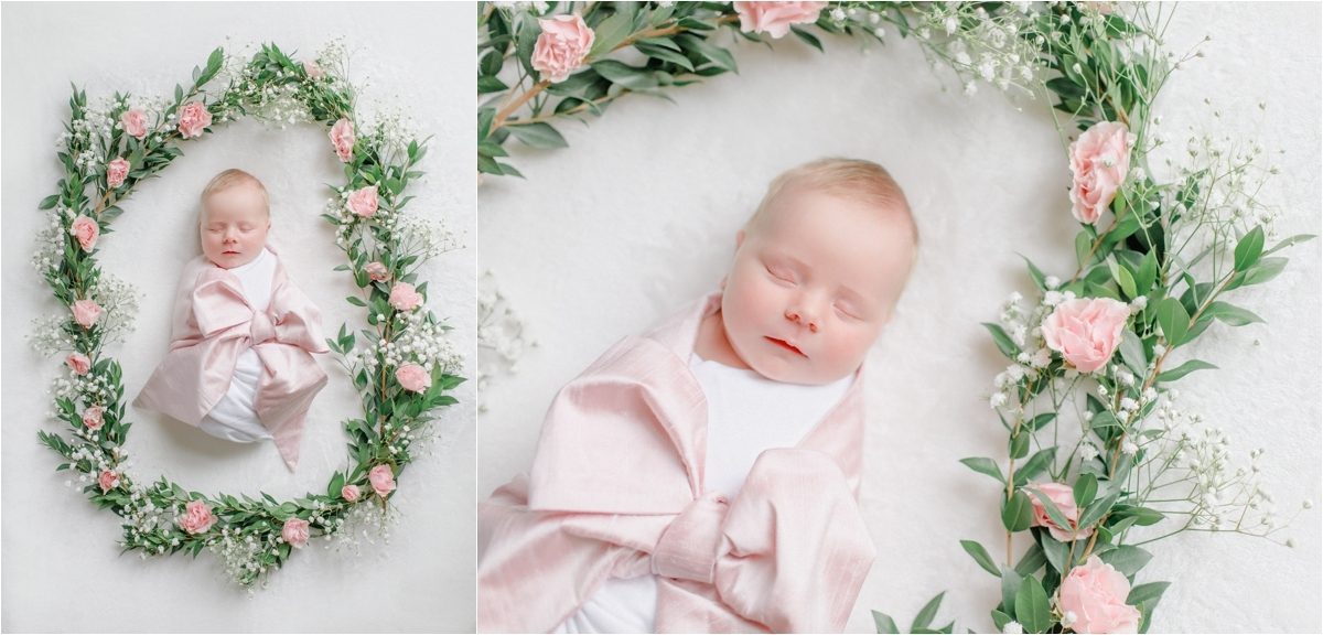 Newborn pictures of a baby girl surrounds by wreath of pink flowers in Knoxville, TN.