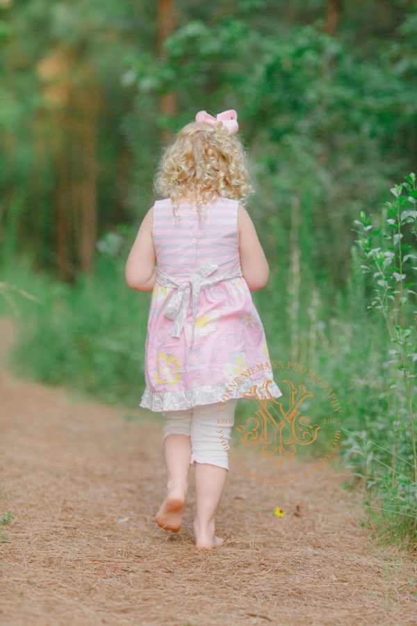 Child Photographer Athens, GA creates artwork of little girl walking in wooded trail.