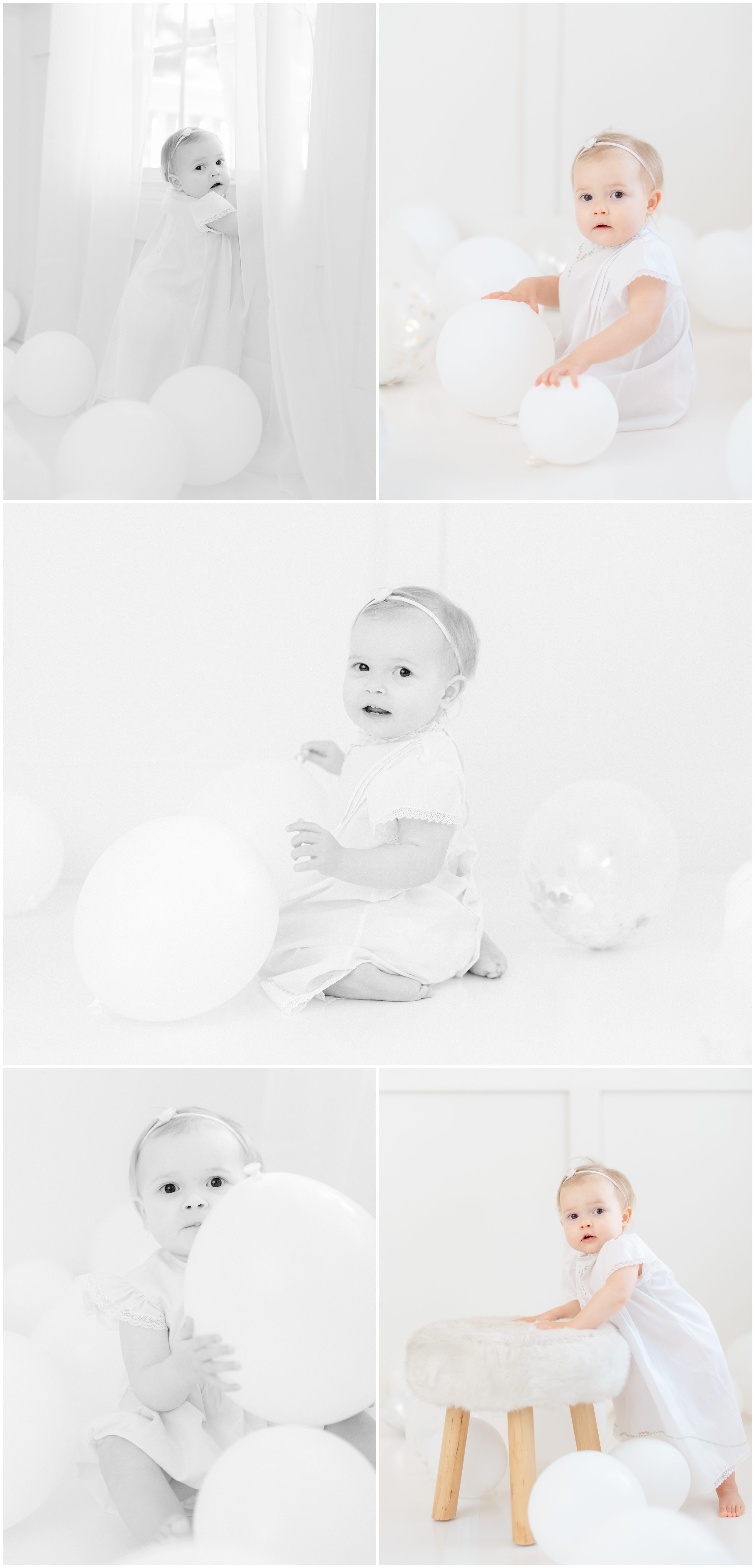 First birthday milestone portrait of baby girl surrounded by white balloons
