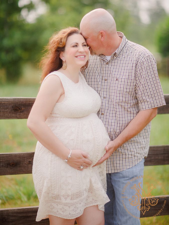 photo of loving couple in the country in Oconee County, GA for their maternity portrait session