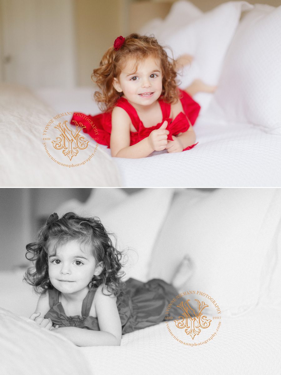 Children's lifestyle photos of a little girl in a red dress on her parents' bed in Athens, GA.