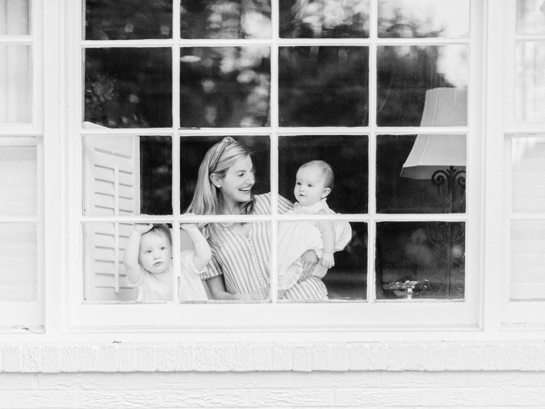 Mother with two daughters in a window in Athens, GA