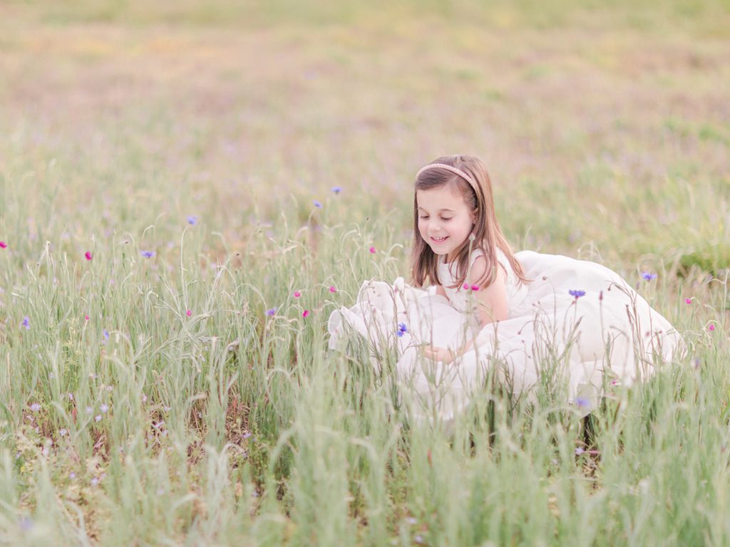 Watkinsville Spring kids photography of a little girl in a field of flowers.