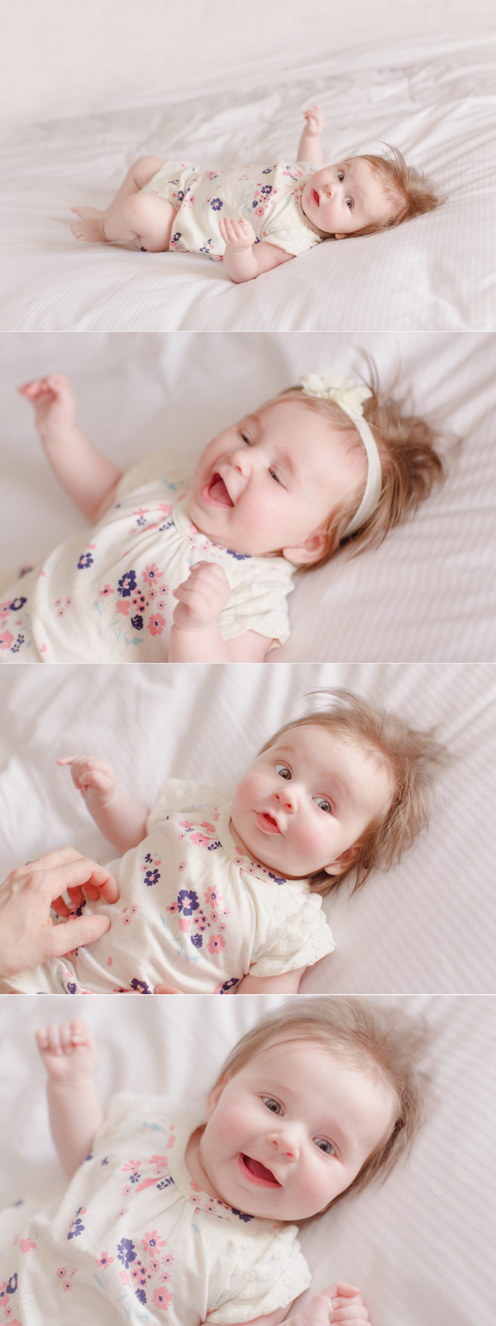 Three month old baby giggling on bed with white linens at a hotel in St. Louis