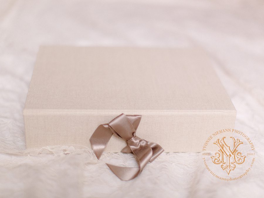 Photo presentation box covered in a natural linen and tied with a silk bow offered by Athens, GA best family photographer, Yvonne Niemann.