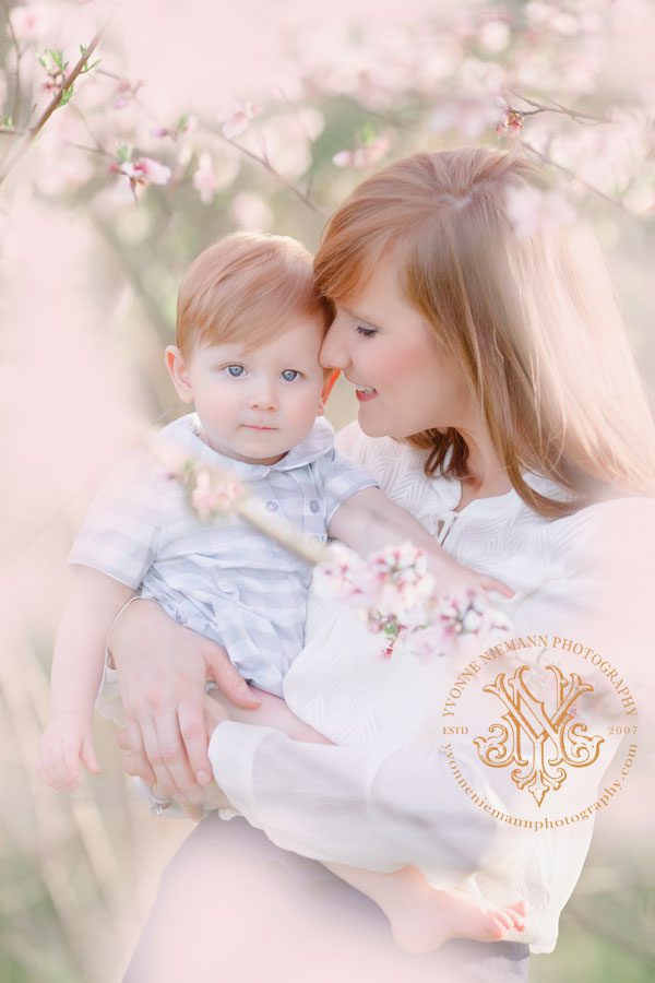 Photo showing the love between a mother and child in a Spring blossoming peach orchard near Athens, GA.