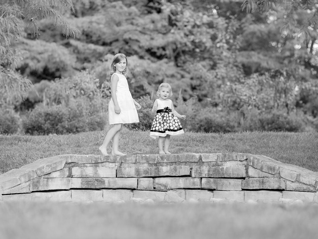 Portrait of two young sisters in a park in Town and Country.