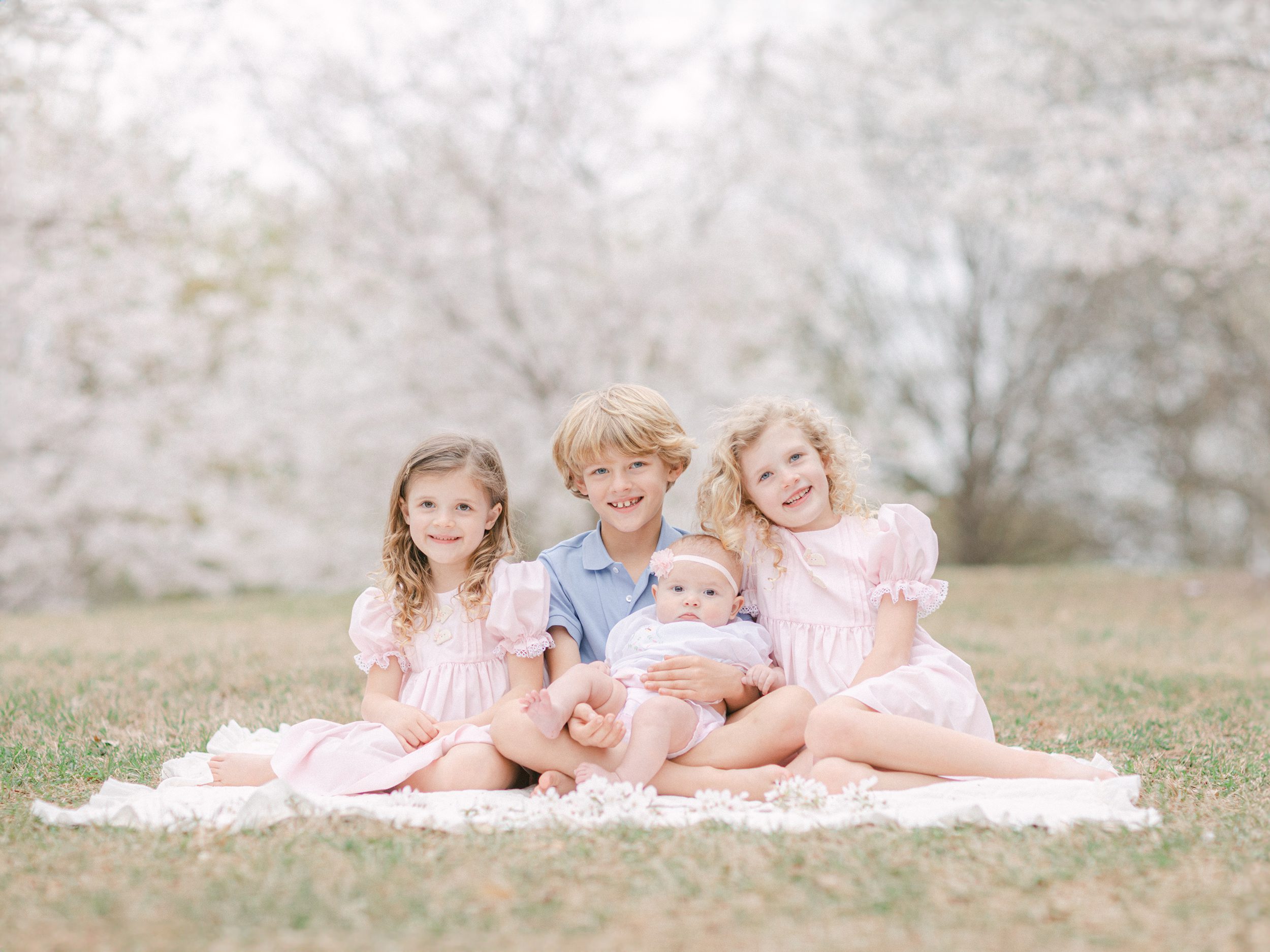Spring sibling photoshoot among cherry trees in Athens, GA.