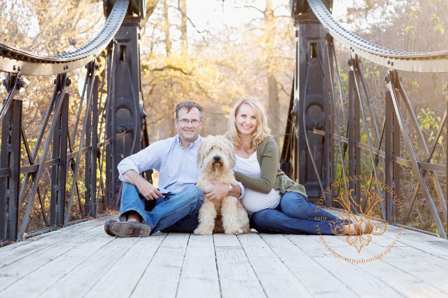 Family photo of couple with their dog on a bridge taken by Athens, GA maternity photographer, Yvonne Niemann Photography.