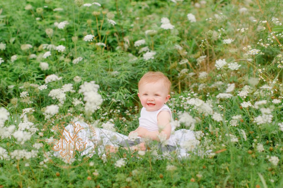 Baby boy in a field of Queen Anne's Lace for his first birthday portraits in Oconee County, GA.