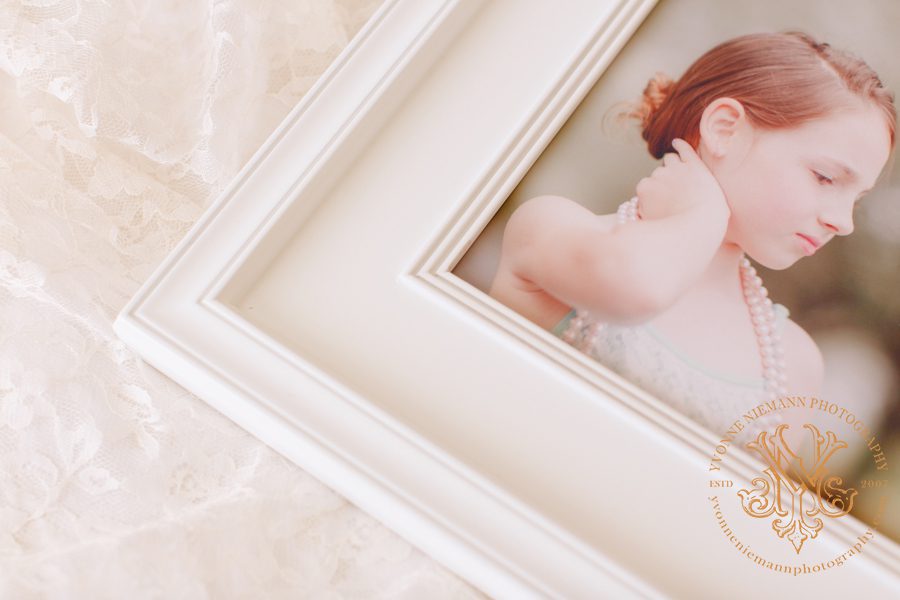 Photo highlighting the details of a high end heirloom photo frame in white.