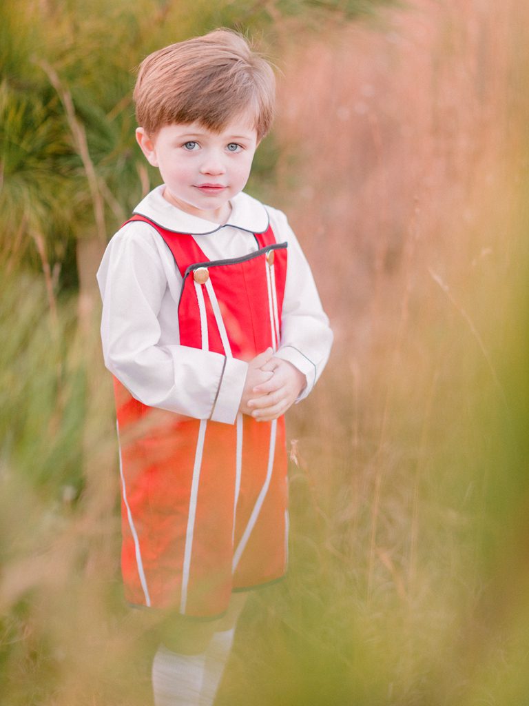 Child's Holiday portrait in field of baby pine trees in Oconee County near Athens, GA.