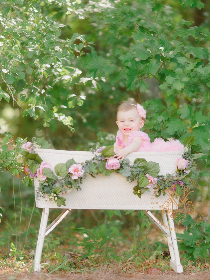 Portrait of baby girl in a bassinet in the woods of Oconee County, GA.