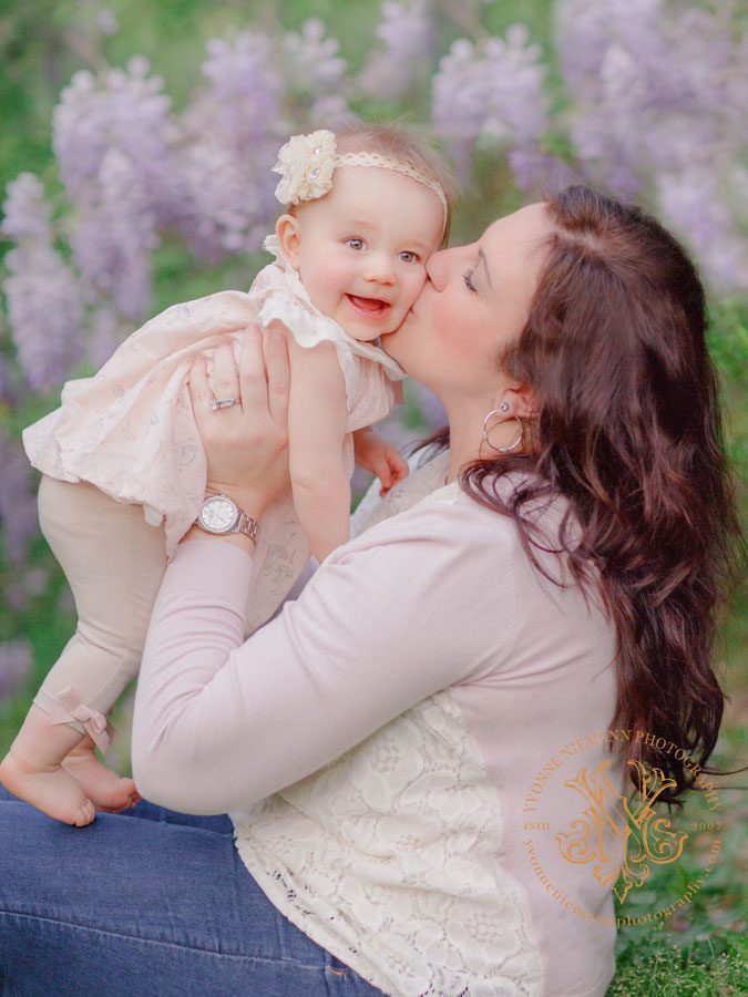 Spring mother daughter photography surrounded by flowering wisteria in Oconee County, GA.