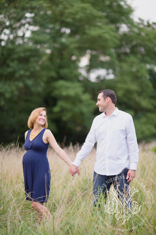 Beautiful maternity portrait of husband and wife in a field in Ballwin, MO taken by Yvonne Niemann Photography.