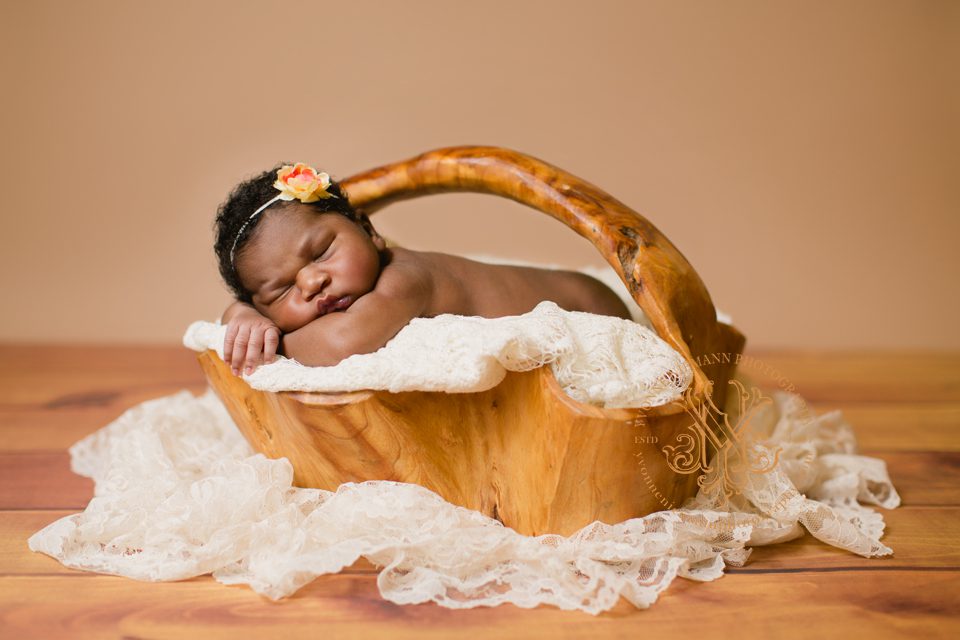 Sweet portrait of sleeping baby in wooden basket onlocation in St. Charles, MO taken by Yvonne Niemann Photography.