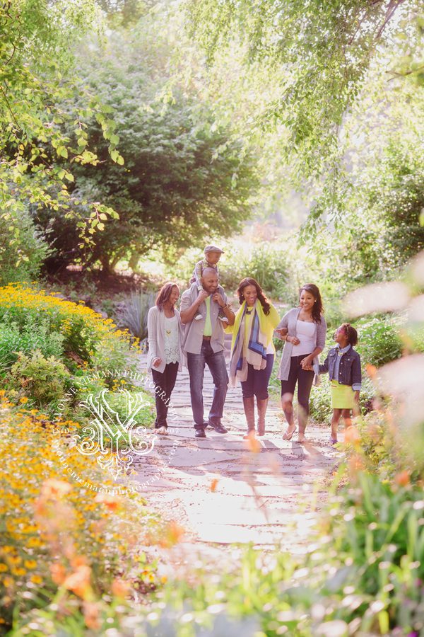 Photo of family walking together in beautiful garden in Athens, GA.