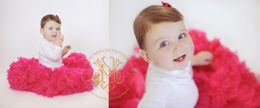 Portrait of a one year old in a pink fluffy tutu by St. Louis Photographer, Yvonne Niemann Photography.